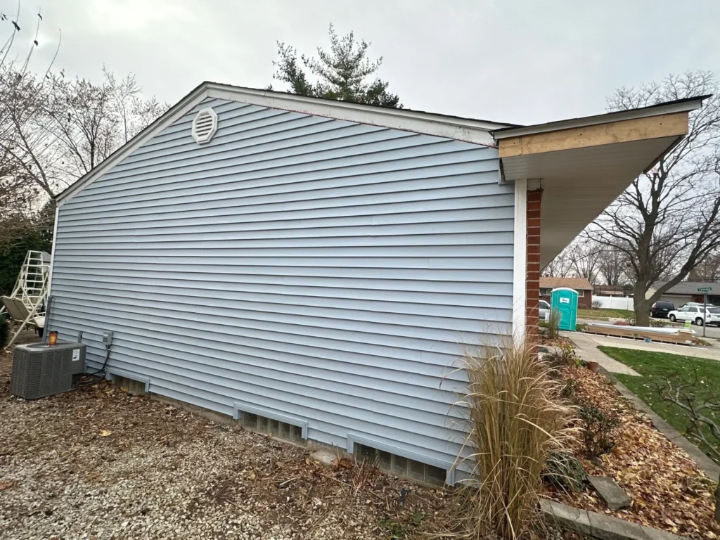 Wide aerial view of a dark grey shingle roof with various planes, chimneys, and vents by Performance Roofing and Siding in Sterling Heights, MI